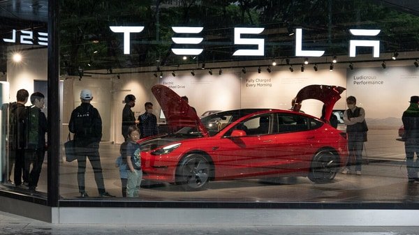 Tesla profit drops as EV maker sticks to more price cuts